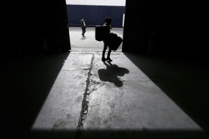 Afghan migrants arrive at a warehouse, which is being used as a shelter for refugees and migrants at the Athens' port of Piraeus, on Monday, Feb. 29, 2016. Border restrictions further north in the Balkans have left thousands of refugees and other migrants stranded in a country that is still wracked by its own financial crisis and unable to seal its lengthy sea border with Turkey. (AP Photo/Thanassis Stavrakis)